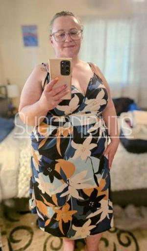 Detroit BBW escort Tasha poses in a colorful floral dress. Detroit BBW escort Tasha poses in a colorful floral dress.